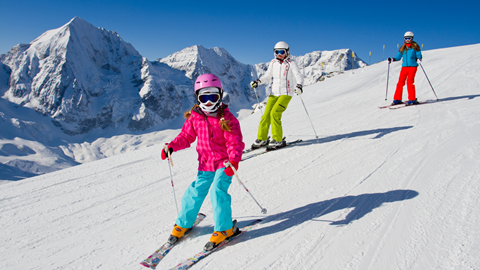 First time skier confidently cruising down a run