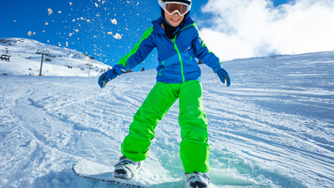 Junior snowboarder enjoying time on the slopes.