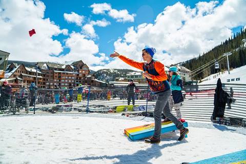 Guests playing corn hole at winter park resort