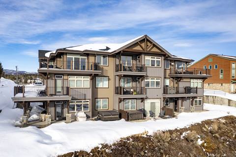 Exterior view of condominium building with snow