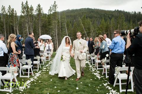 Bride and groom walking down the aisle at their outdoor mountain wedding in Winter Park Colorado