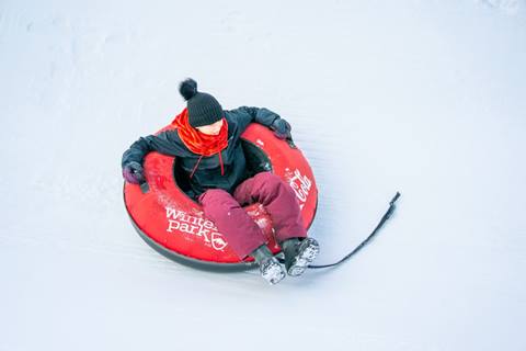 Child in snowtube at the best tubing in Colorado at Winter Park Resort