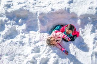 Two children playing in the snow at the best ski resort in colorado winter park resort