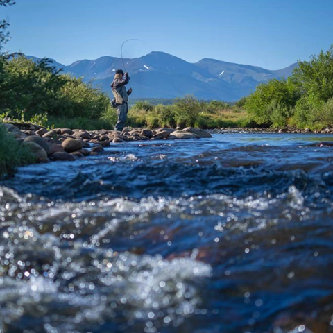 A fisherman casts a line in the Fraser River located near Winter Park Ski Resort