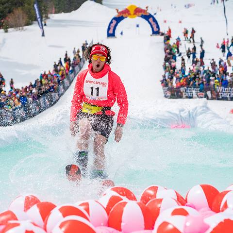 Skier glides across pond as spring bash and splash