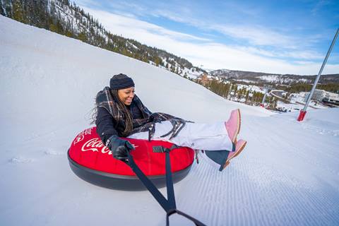 Women tubing at winter park resort