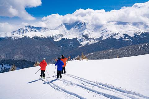 Three people get first tracks at winter park resort.