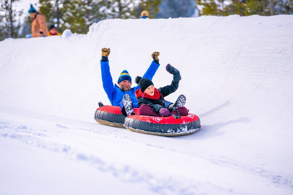 Two people snow tubing at the best snow tubing in Colorado at Winter Park Resort